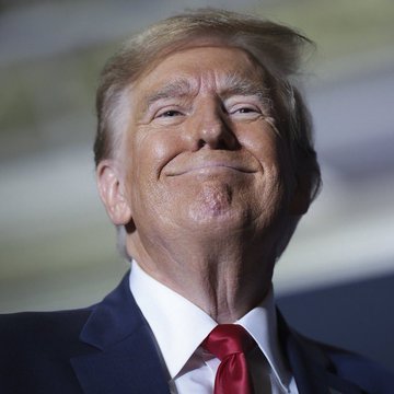 The image features a man wearing a suit, tie, and red shirt with his head tilted back as he smiles at the camera. The caption reads "TRUMP: 'THE USA will be the world' Bitcoin superpower." This statement suggests that Donald Trump is advocating for the United States to become a leader in the cryptocurrency market, specifically Bitcoin.

The man's attire and expression convey confidence and authority, which could be interpreted as him promoting the idea of the US taking control of the digital currency space. The post seems to be making a bold claim about the future of Bitcoin and its potential impact on global power dynamics.