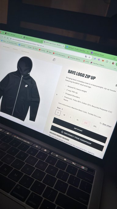 A laptop screen displays a product page for a 'BAYC LOGO ZIP UP' hoodie, shown on a hooded figure, with features listed including being relaxed fit, heavy weight, and made of 80% Cotton 20% Recycled Polyester, priced via the 'DISCONNECT FROM TOMORROWPROOF' website.