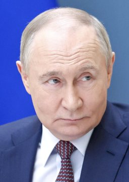 The image shows Vladimir Putin, the Russian President, wearing a dark suit with a white shirt and dark red tie, looking off to the side with a serious expression. The caption relates to him as the figure associated with the United Russia party's projected electoral success across all regions of Russia during the parliamentary election.