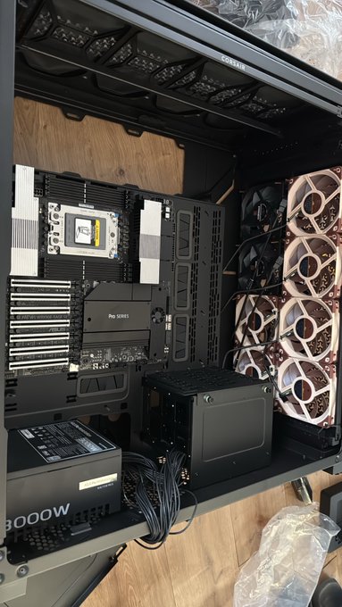 A custom-built high-end PC showcase featuring an ASUS Pro Series motherboard, an 8000W power supply, and a triple-fan cooling configuration with pink-lit components, reflecting the impressive craftsmanship of the custom build.