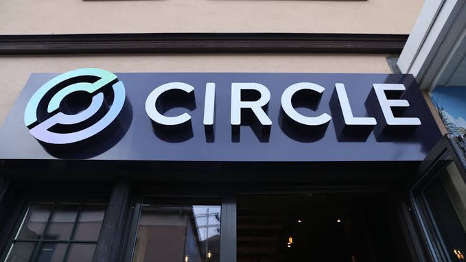 A storefront sign displays the "CIRCLE" logo with its distinctive circular emblem, representing Circle as the company receives approval to operate as a federally regulated US trust bank.