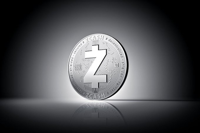 A silver Zcash coin featuring a large "Z" symbol and the inscriptions "ZCASH," "decentralized," and "secure" is displayed against a dark background, visually representing the cryptocurrency's milestone of surpassing $1.23B in 24-hour trading volume.