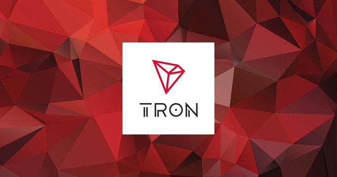 The image features a logo for the cryptocurrency networkTRON. The logo consists of a red triangle with a white border, accompanied by the word "TRON" written in black letters below it. The background of the logo is a vibrant red color, which complements the red triangle and adds to its visual appeal. The text "focus on what is in the image and how it relates to the post." suggests that the viewer should pay attention to the details of the image and consider how it connects to the content of the caption provided.