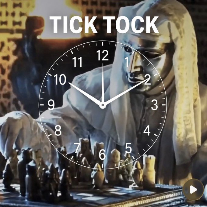 An analog clock face is overlaid on a metallic statue playing chess, with the words 'TICK TOCK' displayed prominently at the top.