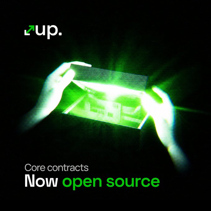 A promotional graphic from up. announces "Core contracts Now open source," featuring two glowing hands holding what appears to be a digital card illuminated in green light against a dark background, with the up. logo in the top left corner—visually reinforcing the message of transparency and openness about their core smart contracts being publicly available.