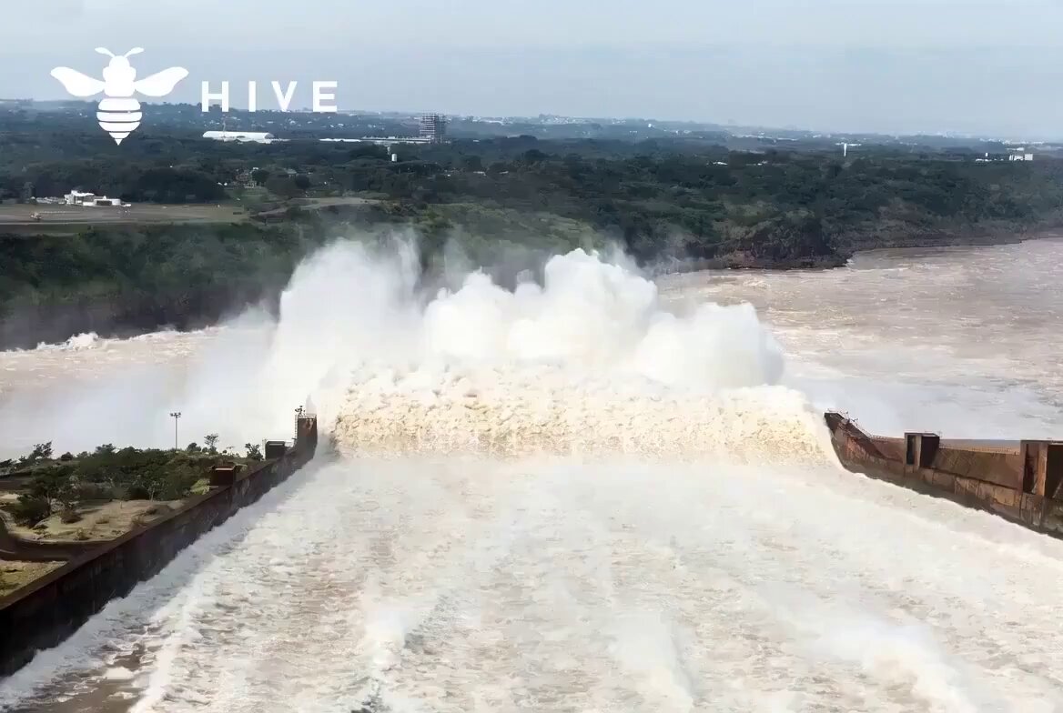 The image shows a large dam with water flowing through it, creating a white spray that can be seen from above. The dam appears to be an impressive structure, possibly used for generating electricity or other purposes. In the background, there are trees visible, adding a touch of nature to the scene. The post also mentions Bitcoin mining and ethical global money, which could suggest that this dam is located in a region where Bitcoin mining operations are taking place. This implies that the dam might be contributing to the energy needs for these activities or even being used as an unconventional source of power for Bitcoin mining.