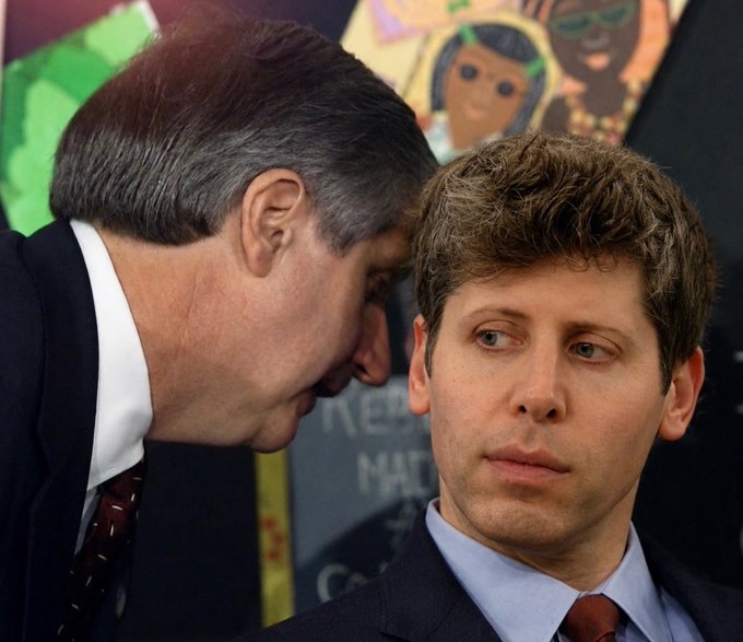 A distinguished man in a suit whispers "Sir, I think we are cooked" into the ear of a younger man, while a children's drawing showing the phrase "READ ME A STORY" is visible on a chalkboard in the background.