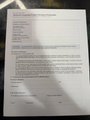 A small, blurry image showing what appears to be a printed document or text on a screen.