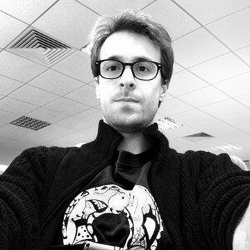 A man named Drake, referenced in the post as Ethereum Foundation researcher Justin Drake, is shown in a black-and-white selfie wearing glasses and a graphic-print t-shirt, likely taken in an institutional or formal setting suggested by the drop ceiling.