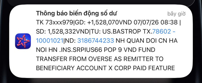 A Vietnamese bank notification (Thông báo biến động số dư) shows a credit of +1,528,070 VND received at 08:38 on 07/07/26 from a US-based sender in BASTROP, TX, ending the day with a balance of 1,528,332 VND. This corresponds to the post's message about money (X) finally arriving, though the sender humorously notes it was already spent paying off creditors.