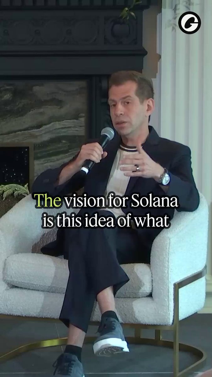 The image features a man sitting in a chair with his feet up while holding a microphone. The caption below him reads "The vision for Solana is this idea of what", which seems to be related to the concept of stablecoins or financial inclusion.