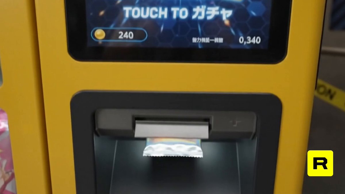 "Touch To Japan" sign on a vending machine, with a white paper bag being inserted into the machine.