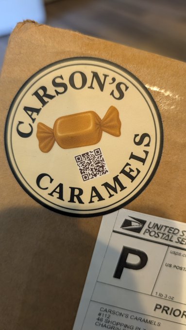 A brown paper package features a 'CARSON'S CARAMELS' sticker with a QR code, alongside a USPS Priority shipping label.