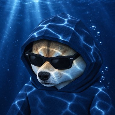 A Shiba Inu dog wearing black sunglasses and a blue water-patterned hoodie, posed underwater with light rays streaming down and bubbles rising.