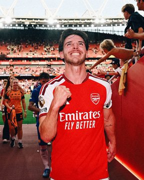 Arsenal player in a red "Emirates FLY BETTER" jersey celebrates with a clenched fist on the pitch at a packed stadium, capturing the post-match joy that likely fueled the bettor's $800K+ payout on Stake backing the Premier League champions.