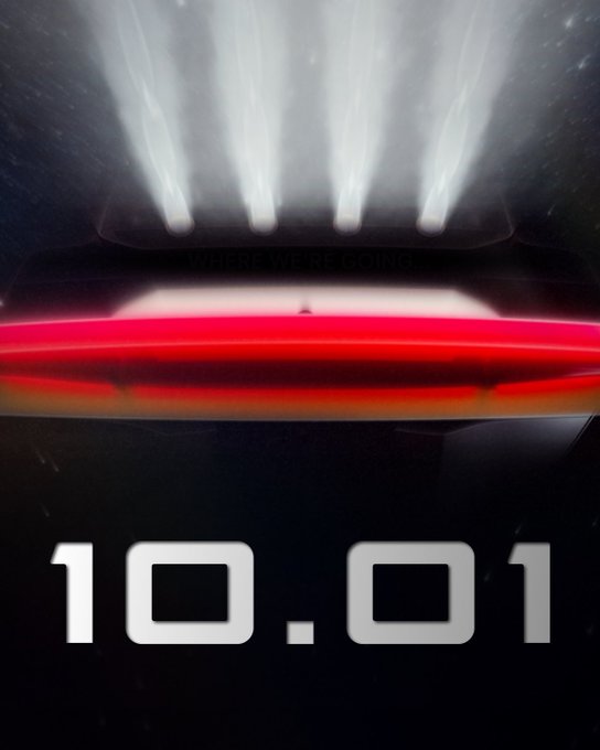 A movie poster-style image featuring the rear of a car with illuminated red taillights and bright white headlights shining upward, with the text 'WHERE WE'RE GOING' and a large '10.01' at the bottom.