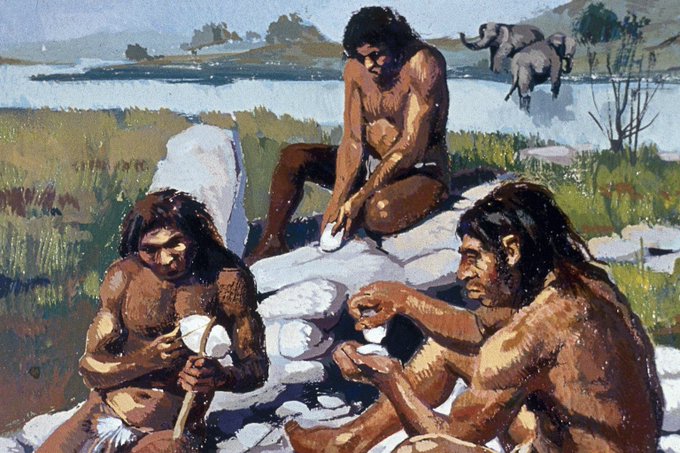 A painted illustration depicting prehistoric humans engaged in stone tool-making activities in an outdoor landscape with elephants visible in the background.