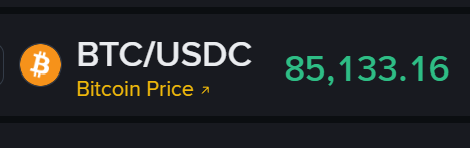 A digital ticker display showing 'BTC/USDC Bitcoin Price' at 85,133.16 with the Bitcoin logo.