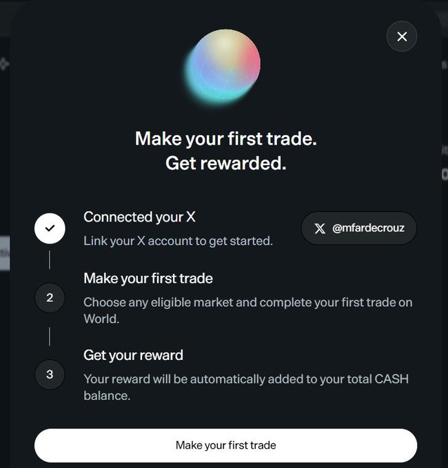 A promotional pop-up from World.xyz titled "Make your first trade. Get rewarded." outlines a three-step process to qualify for an airdrop: (1) Connected your X account (@mfardecrouz shown as verified), (2) Make your first trade on an eligible market, and (3) Get your reward automatically added to your CASH balance. The image illustrates the final onboarding step referenced in the post, showing the X connection confirmation and a "Make your first trade" button to claim the reward.