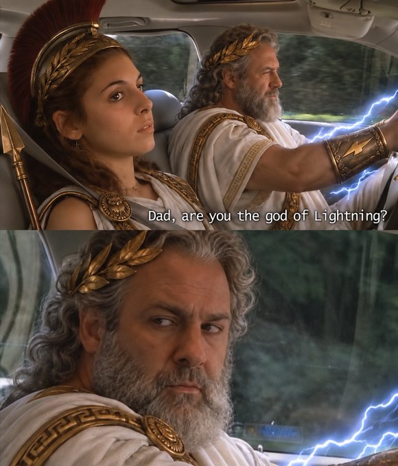 A father (in a Zeus costume, complete with lightning effects) and daughter (dressed as a Greek warrior/goddess) sit in a car, with the daughter asking, "Dad, are you the god of Lightning?" The joke plays on crypto culture, where "GM" (Good Morning) is a common greeting, often associated with bullish market sentiment or meme coin enthusiasm—humorously suggesting that dad isn't actually Zeus but rather a crypto trader riding lightning-fast gains.