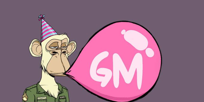 A cartoon monkey wearing a party hat and a military-style jacket with a name tag, blowing a pink balloon that says 'GM'.
