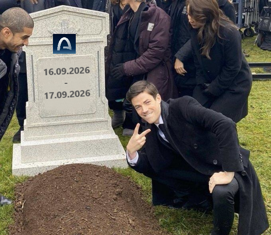A photo showing a man kneeling and smiling next to a tombstone engraved with the dates '16.09.2026 - 17.09.2026', while others in dark clothing stand behind him.