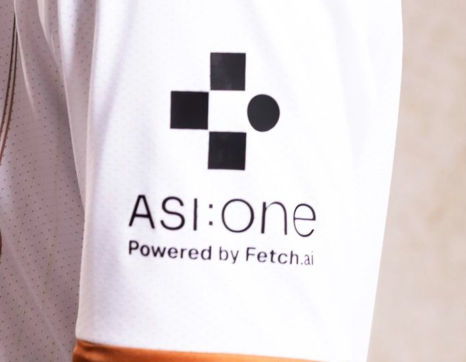 The image shows "ASI:One Powered by Fetch.ai" on a white garment, suggesting Fetch.ai's involvement in football. The accompanying post references "$FET," likely referring to Fetch.ai's cryptocurrency token, and claims "FET taking over English football."