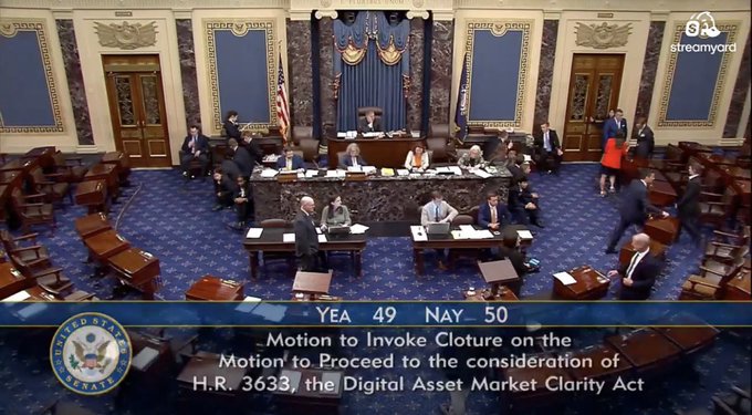 A screenshot from a U.S. Senate broadcast (streamyard) showing the Senate floor with the tally "YEA 49 NAY 50" displayed, along with text reading "Motion to Invoke Cloture on the Motion to Proceed to the consideration of H.R. 3633, the Digital Asset Market Clarity Act."