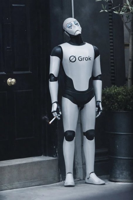 The image features a large robot statue standing outside of a black door with its arms raised high above its head. The robot has a sad expression on its face as if it's crying or mourning something. In front of the door, there are two potted plants - one is located to the left side and the other is positioned more towards the center. The background includes a street view that appears to be a sidewalk with some buildings visible in the distance. There is also an image of a person holding a cigarette on the right side of the photo.