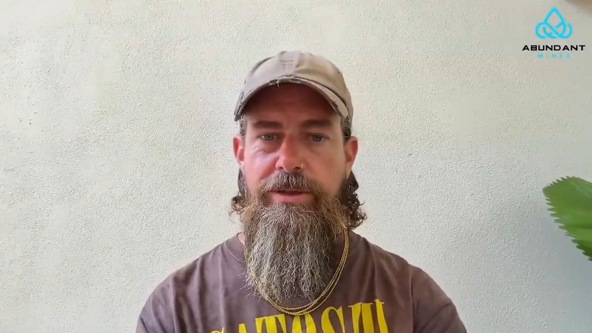A bearded man wearing a baseball cap and a "SMASH" t-shirt speaks to the camera. The image is branded with the "Abundant Mines" logo, fitting the Bitcoin mining quote.