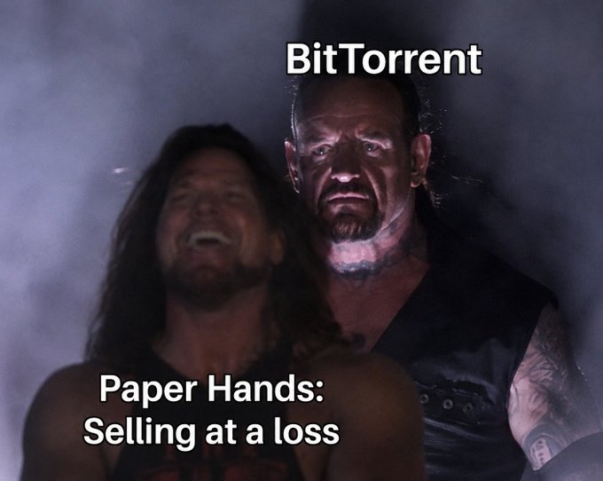A meme featuring two men labeled 'BitTorrent' (standing) and 'Paper Hands: Selling at a loss' (laughing).