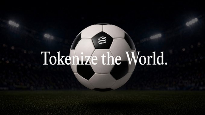 Promotional image showing a black and white soccer ball with the text 'Tokenize the World.' overlaid, set against a blurred stadium background at night.