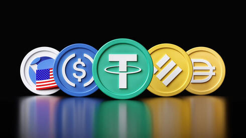 Five cryptocurrency coins are displayed against a black background, including one with the US flag and others featuring the dollar sign ($), Tether (T), Binance, and DAI symbols.
