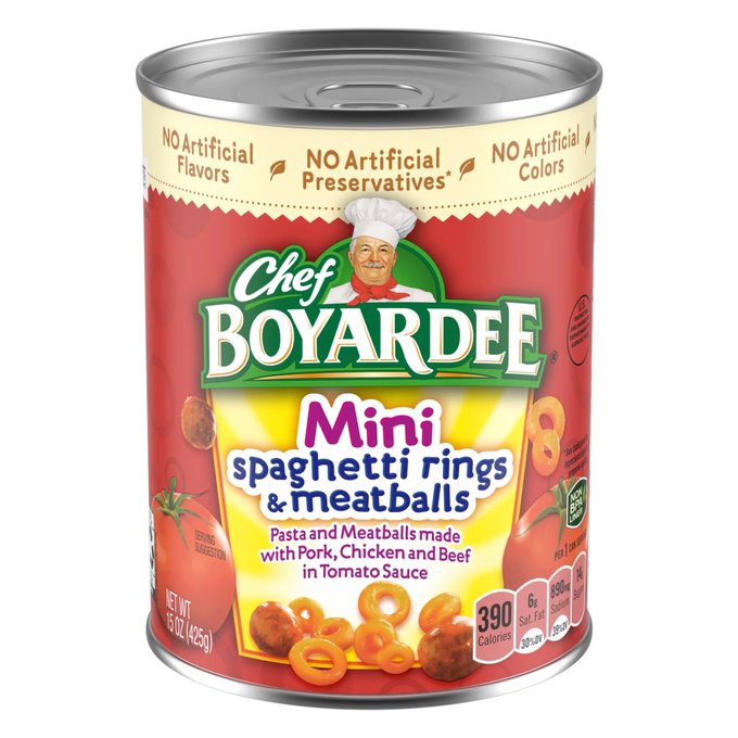 A can of Chef Boyardee Mini Spaghetti Rings & Meatballs (15 oz/425g) with 390 calories, featuring the iconic chef mascot and a red label advertising "No Artificial Flavors, Preservatives, or Colors." The nostalgic canned pasta product contrasts humorously with the modern "NFTs" reference, highlighting how digital collectibles have replaced tangible branded goods as trendy cultural artifacts.