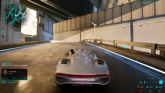 A screenshot from the video game Cyberpunk 2077 shows a futuristic silver sports car driving on a road, with the in-game radio playing 'Breach Alert' by Grafitis FM.