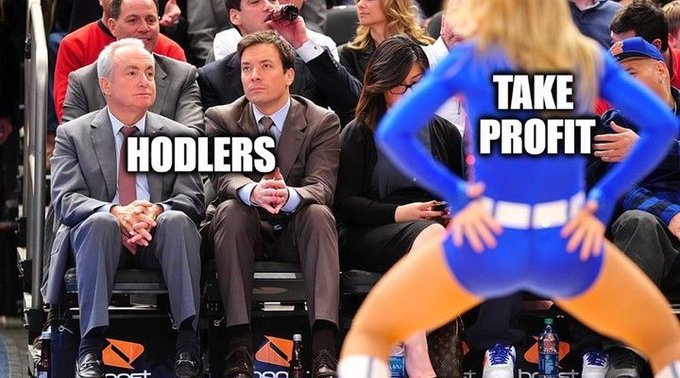 A meme image showing two suited men sitting courtside at a basketball game looking disinterested, labeled 'HODLERS', while a cheerleader in front of them is labeled 'TAKE PROFIT'.