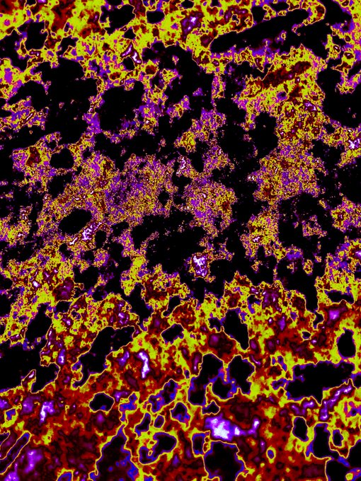 A vibrant, abstract pattern resembling a fiery or cosmic texture with bright yellow, red, and purple swirling against a black background.