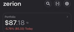 A dark-themed mobile app screenshot for 'zerion' showing a portfolio balance of '$87.18' with a -5.76% decline ($5.33) for the day.