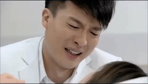 The image features a man with short hair wearing a white shirt, looking at another person who has long brown hair. They are both sitting next to each other, possibly engaged in conversation or sharing an intimate moment. The background of the image appears to be a plain white wall, which contrasts with the subjects and emphasizes their presence in the frame. The caption " Tonight, ETH bulls" suggests that this scene might be related to a sports event or a social gathering involving fans supporting their favorite team.