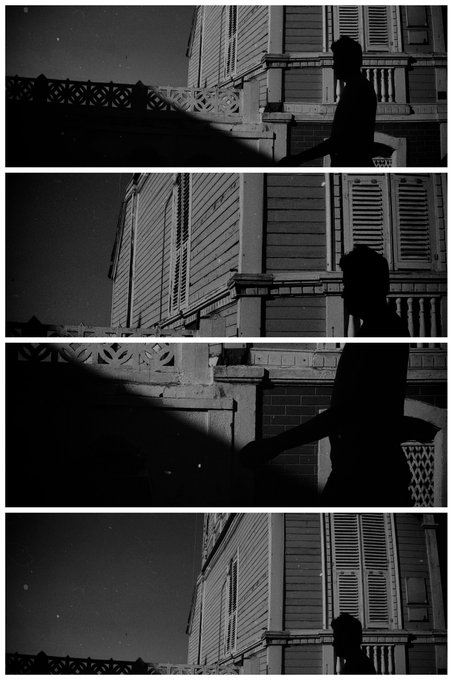 A black and white four-panel film strip showing a silhouetted figure standing near an ornate building with balconies and shuttered windows at night.