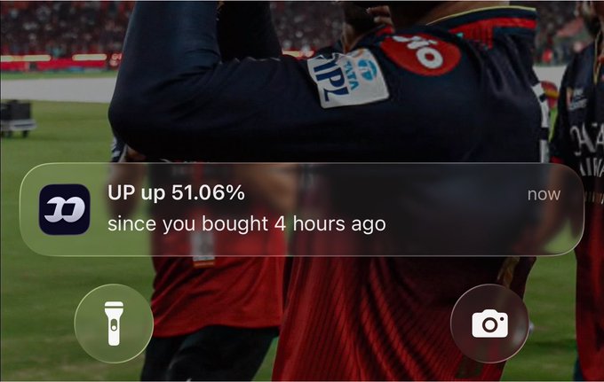 A stock ticker notification shows 'UP up 51.06% since you bought 4 hours ago' overlaid on footage of athletes in red and navy uniforms.