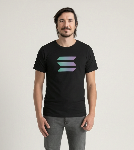 A man models a black t-shirt featuring the iridescent Solana logo (≡), which connects to the post noting that Vlad Tenev was convinced to wear Solana merchandise at a secretive World.xyz photoshoot.