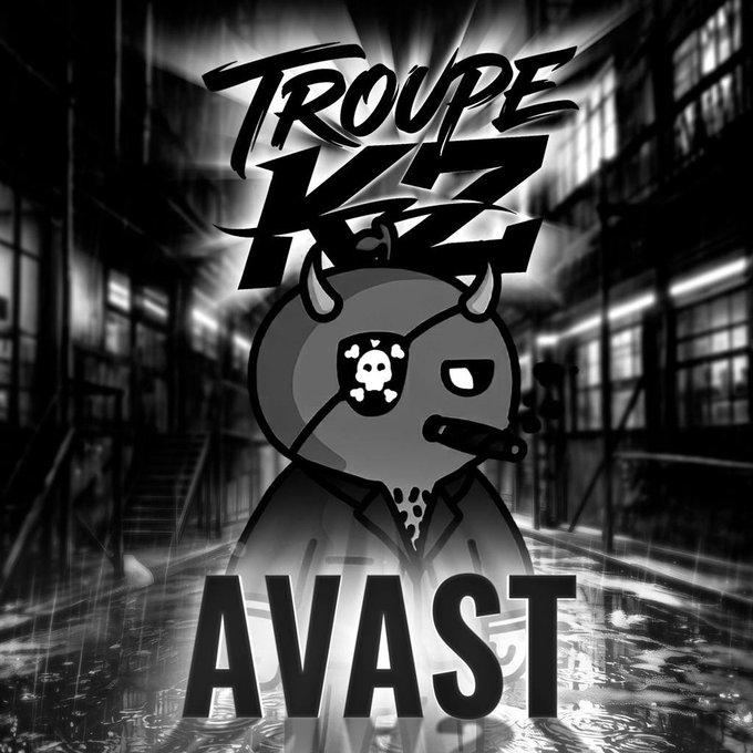 The black-and-white graphic features the bold text "TROUPE KZ" at the top and "AVAST" at the bottom, surrounding an anime-style character with horns and a skull-and-crossbones eyepatch in an industrial setting. This serves as the branding/logo for Troupe KZ, the crypto trading group referenced in the post, visually conveying the group's edgy, dedicated identity.