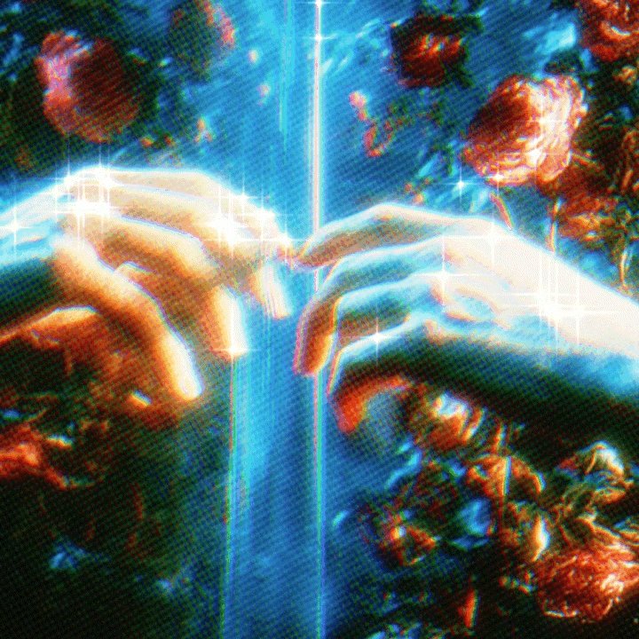 The image features a pair of hands reaching out towards each other, with their fingers almost touching. The background is filled with red roses, creating an artistic and surreal atmosphere. The photo has a blue tint that gives it a dreamy appearance. The caption reads "so close it burns" which could be interpreted as the intensity or closeness of the connection between the two hands in the image.