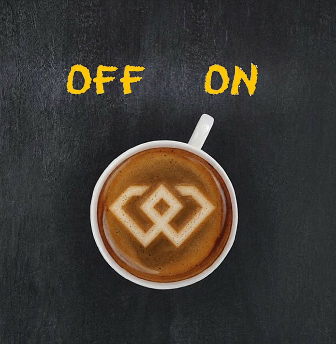 A cup of coffee with latte art forming a geometric diamond logo, placed on a dark surface with the words 'OFF' and 'ON' written in yellow chalk-style text above.