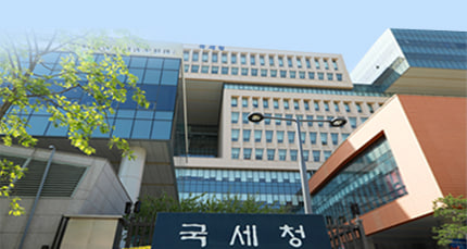 The image shows the National Tax Service building in Korea, identifiable by the Korean text "국세청" (National Tax Service) visible on the building's signage. This government headquarters is relevant to the post about the National Tax Service's new initiative to track virtual assets in personal wallets to close tax gaps.