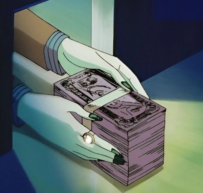 The image shows green-skinned hands with dark green nail polish and a gold ring holding a thick stack of banded cash. The post's message, "We're making money this year," directly parallels the visual of gripping a substantial bundle of bills, emphasizing a tone of financial success and prosperity.