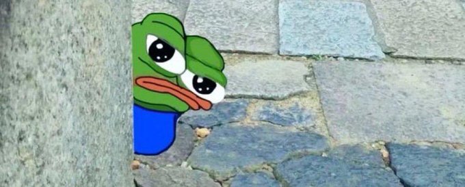A sad Pepe the Frog meme peeking from behind a stone corner, with large watery eyes and a downturned mouth.