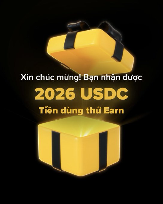 The image shows an open glowing yellow gift box with text reading "Xin chúc mừng! Bạn nhận được 2026 USDC Tiền dùng thử Earn" (Congratulations! You received 2026 USDC trial Earn funds), promoting a Binance promotional giveaway that relates to the post's excitement about unexpected crypto earnings.
