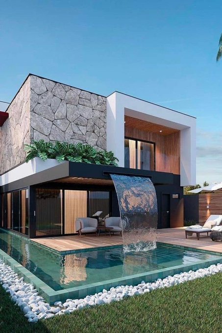 A modern luxury home features a striking cascading water feature that flows into a sleek swimming pool, framed by natural stone accents and contemporary architecture.

The post about spending time playing the @sleepagotchi game on Telegram evokes relaxation and leisure, much like the serene, vacation-like ambiance of this luxurious poolside retreat.